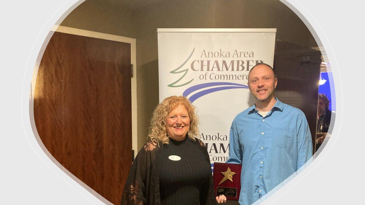 Kris standing with her grandchildre